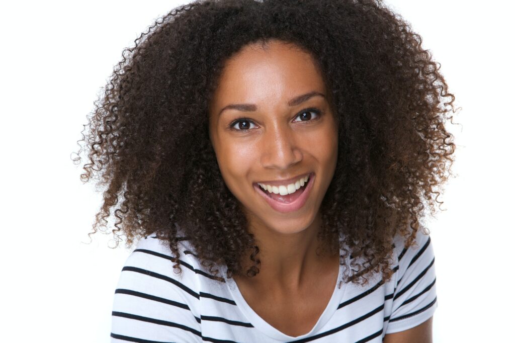 Happy young black woman laughing